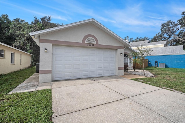 ranch-style house with central AC, a front yard, and a garage