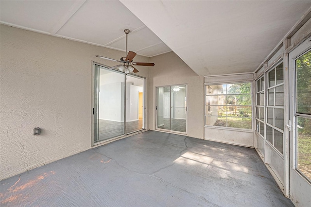 unfurnished sunroom featuring ceiling fan