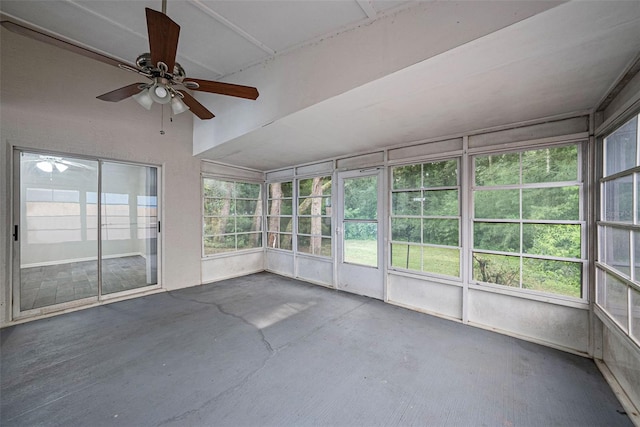 unfurnished sunroom with ceiling fan and plenty of natural light