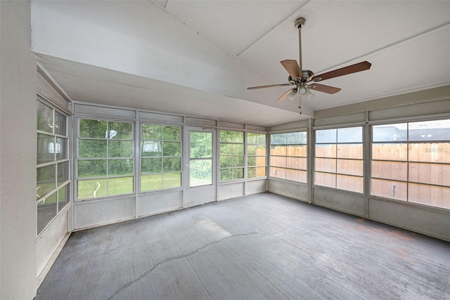 unfurnished sunroom with ceiling fan and plenty of natural light