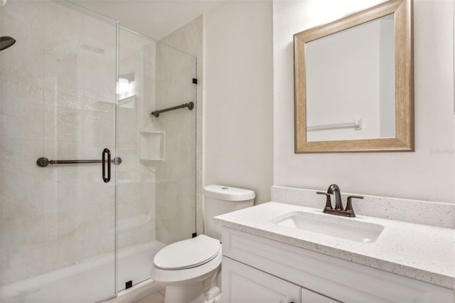 bathroom featuring walk in shower, vanity, and toilet