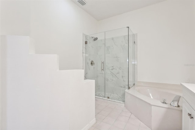 bathroom featuring independent shower and bath, vanity, and tile patterned floors