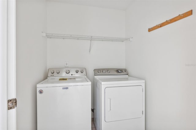 clothes washing area with washer and clothes dryer