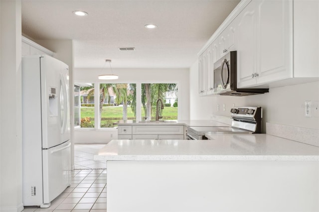 kitchen featuring pendant lighting, kitchen peninsula, sink, white cabinetry, and appliances with stainless steel finishes