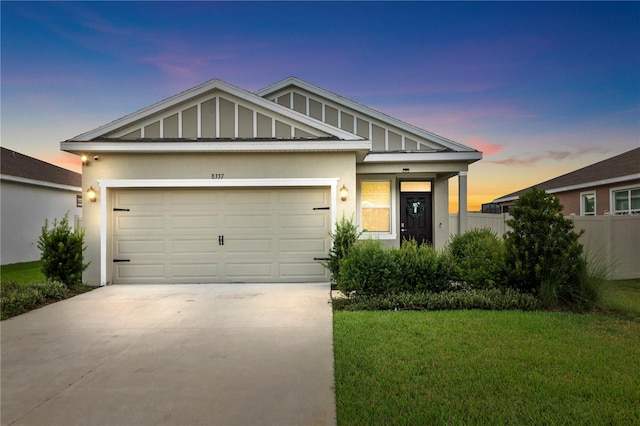 view of front of house featuring a yard and a garage