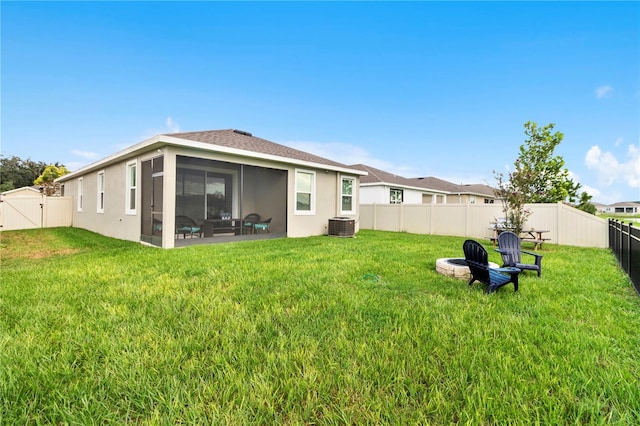 rear view of property featuring a yard, cooling unit, and a patio area