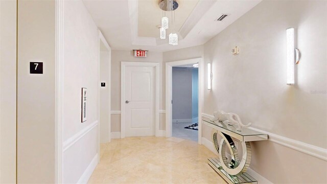 corridor featuring a tray ceiling