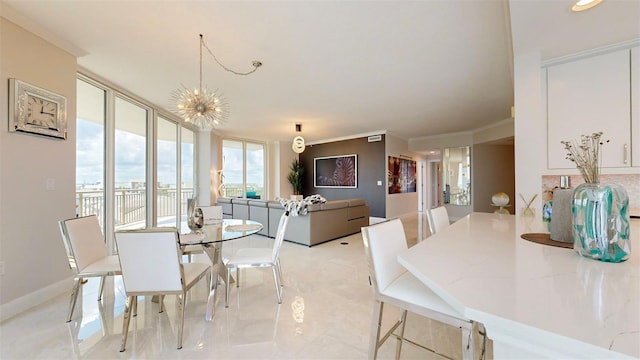 dining area featuring an inviting chandelier and crown molding