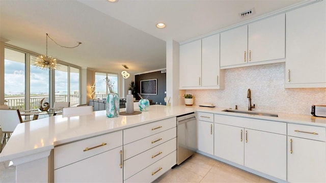 kitchen with decorative backsplash, dishwasher, kitchen peninsula, sink, and white cabinets