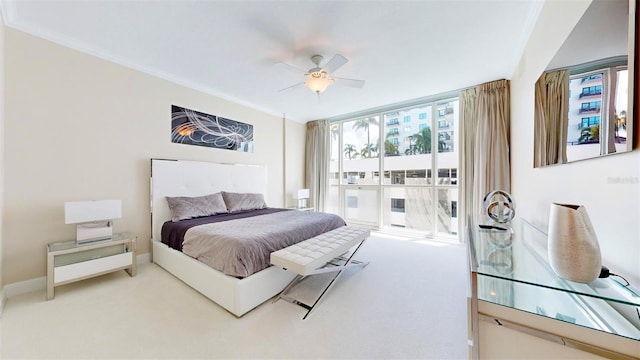 bedroom with ornamental molding, carpet, and ceiling fan