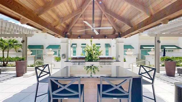 view of patio featuring a gazebo, exterior bar, and a grill