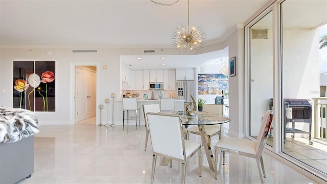 dining room with crown molding and a chandelier