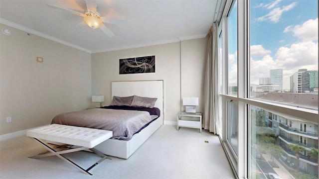 carpeted bedroom featuring crown molding and ceiling fan