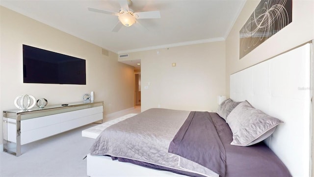 carpeted bedroom featuring crown molding and ceiling fan