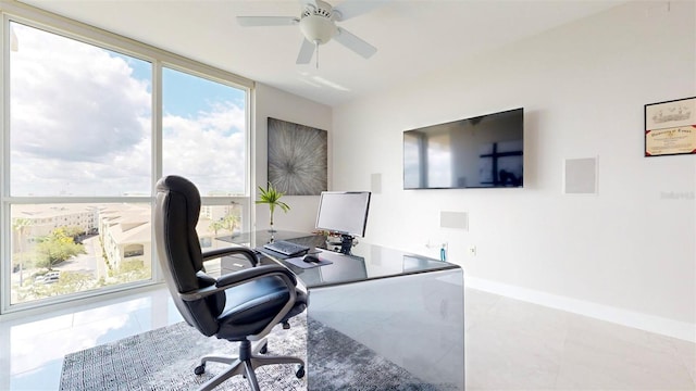 tiled home office featuring plenty of natural light and ceiling fan