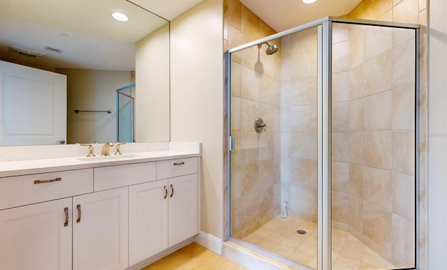 bathroom with vanity, tile patterned flooring, and a shower with door