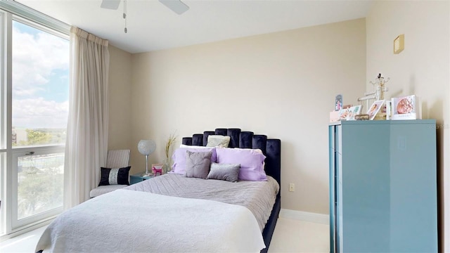 carpeted bedroom with multiple windows and ceiling fan