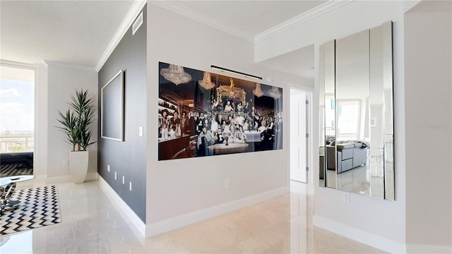 hall with ornamental molding and plenty of natural light