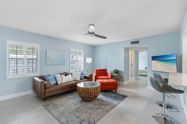 living room with plenty of natural light and ceiling fan