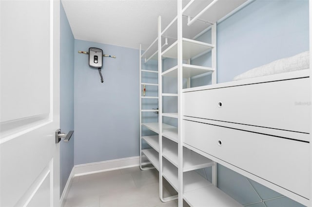 spacious closet featuring tile patterned floors