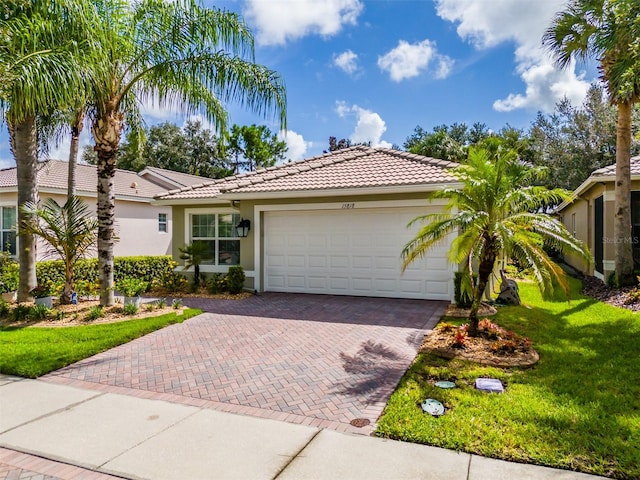 view of front of property with a garage and a front yard