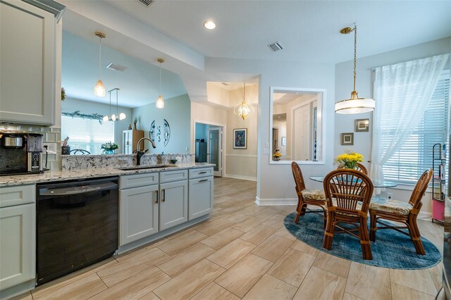 kitchen featuring a chandelier, decorative light fixtures, sink, light stone countertops, and black dishwasher