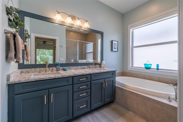 bathroom with vanity, separate shower and tub, wood-type flooring, and ceiling fan