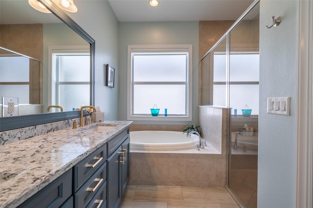 bathroom featuring vanity, independent shower and bath, and tile patterned flooring