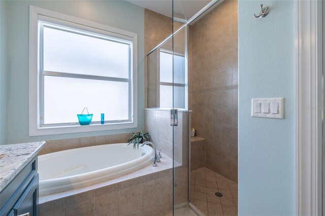 bathroom featuring a wealth of natural light, shower with separate bathtub, and vanity