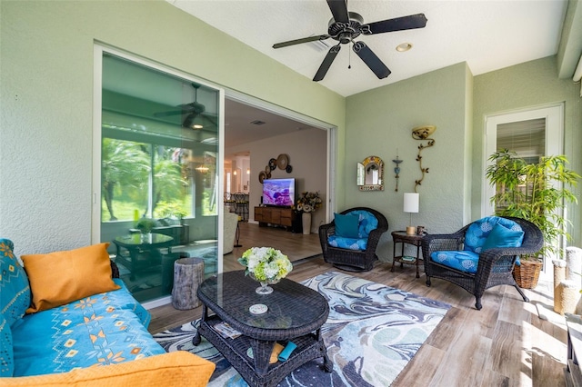 living room with ceiling fan and light hardwood / wood-style floors