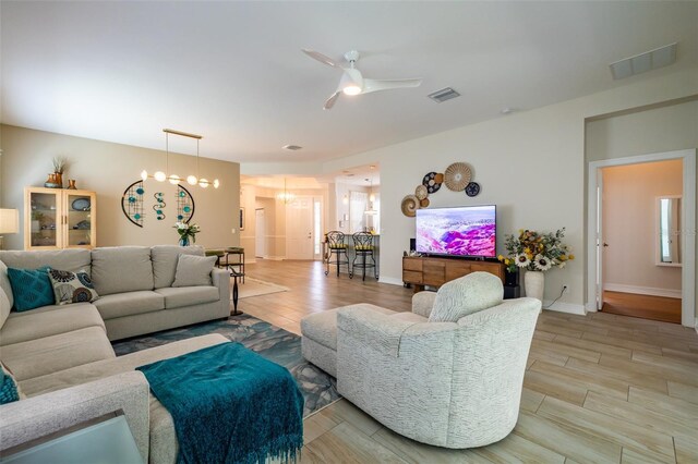 living room featuring light hardwood / wood-style flooring and ceiling fan