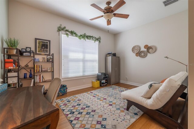 office space featuring ceiling fan and light wood-type flooring