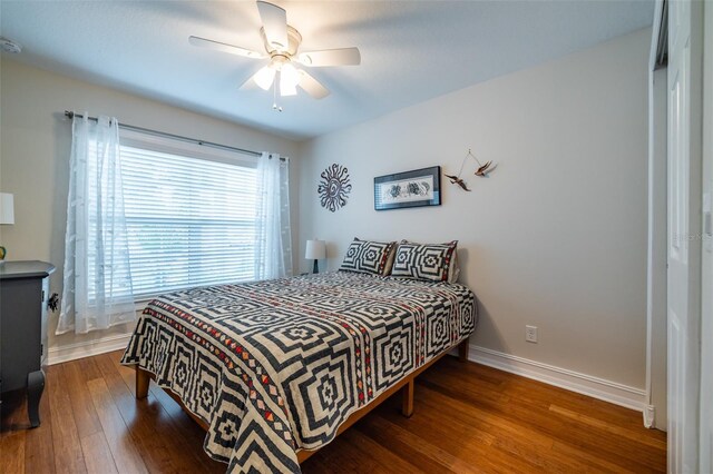 bedroom featuring dark wood-type flooring and ceiling fan