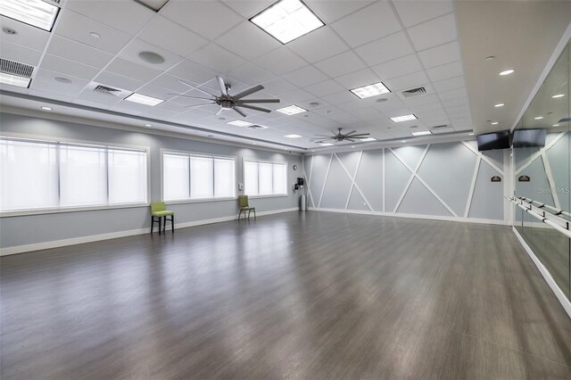 spare room with a paneled ceiling, ceiling fan, and dark hardwood / wood-style floors