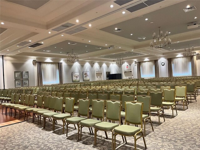 home theater room featuring carpet flooring, coffered ceiling, an inviting chandelier, and beamed ceiling