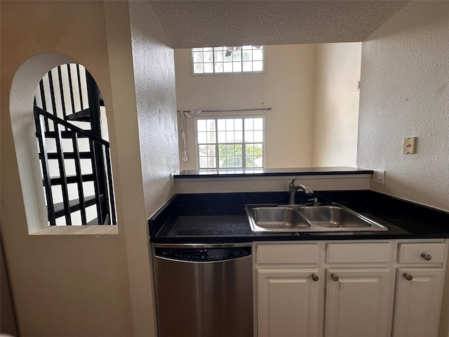 501 Knights Run Ave Unit 1327, Tampa, FL 33602 - kitchen featuring stainless steel dishwasher, white cabinets, a sink, and dark countertops
