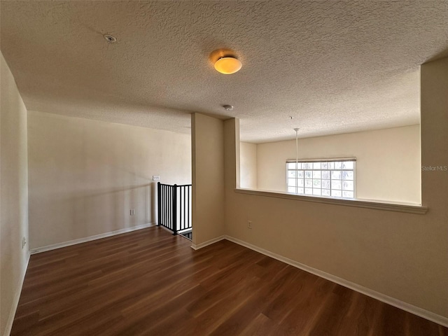501 Knights Run Ave Unit 1327, Tampa, FL 33602 - unfurnished room featuring baseboards, a textured ceiling, and dark wood finished floors