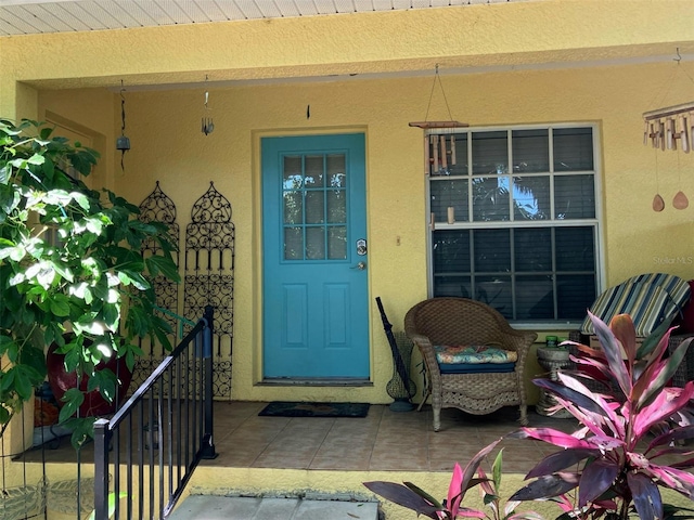 view of exterior entry featuring a porch