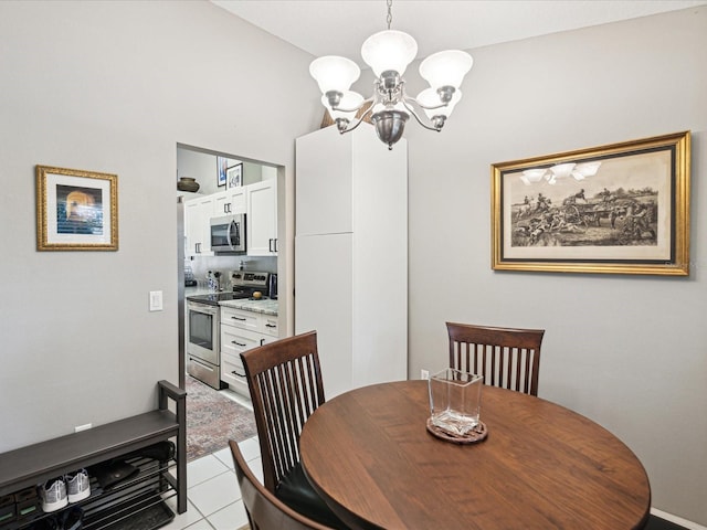 tiled dining space featuring a chandelier