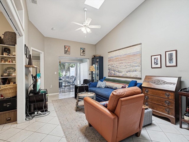 living room featuring ceiling fan, light tile patterned floors, high vaulted ceiling, and a skylight