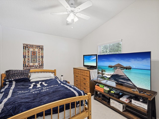 tiled bedroom with ceiling fan and vaulted ceiling