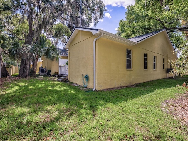 view of side of home with a lawn