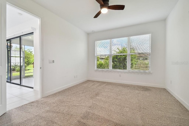 spare room with ceiling fan, light carpet, and a healthy amount of sunlight