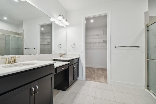 bathroom featuring vanity, an enclosed shower, and tile patterned floors