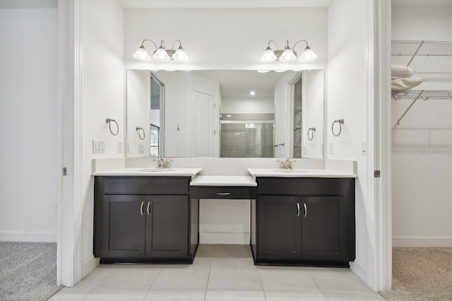 bathroom with vanity, a shower with shower door, and tile patterned floors