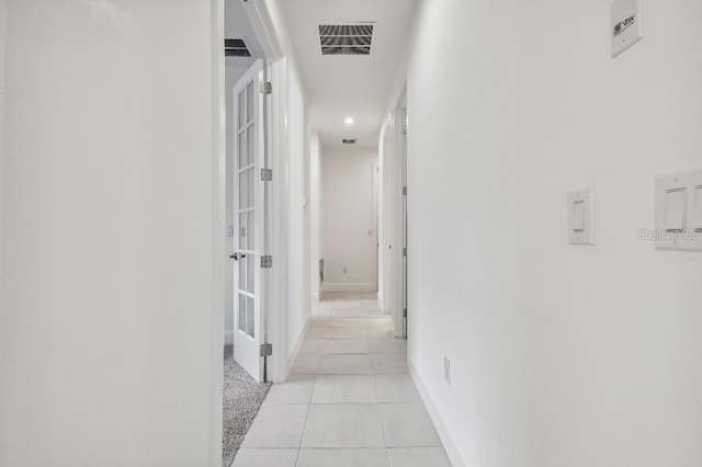 hallway featuring light tile patterned floors