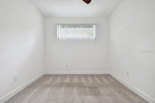 spare room with ceiling fan and carpet flooring