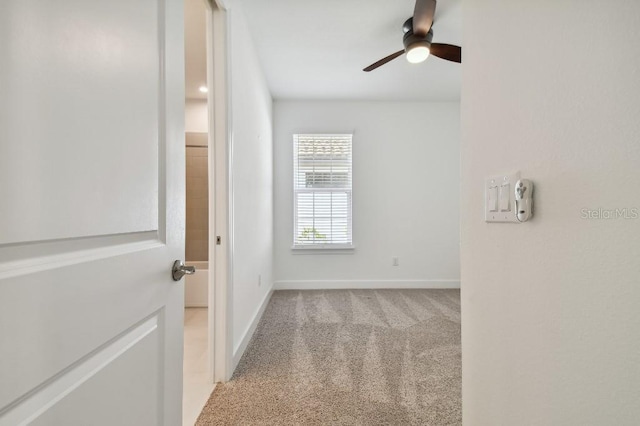 carpeted empty room with ceiling fan