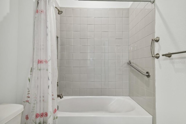 bathroom with toilet and shower / bath combo