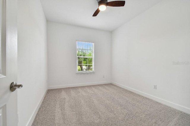 carpeted spare room featuring ceiling fan